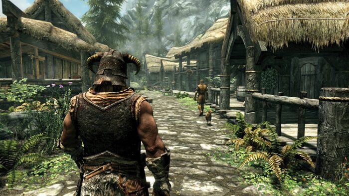 Skyrim's lush visuals of a small town surrounded by trees and mountains. You follow your customized character from behind their shoulder.