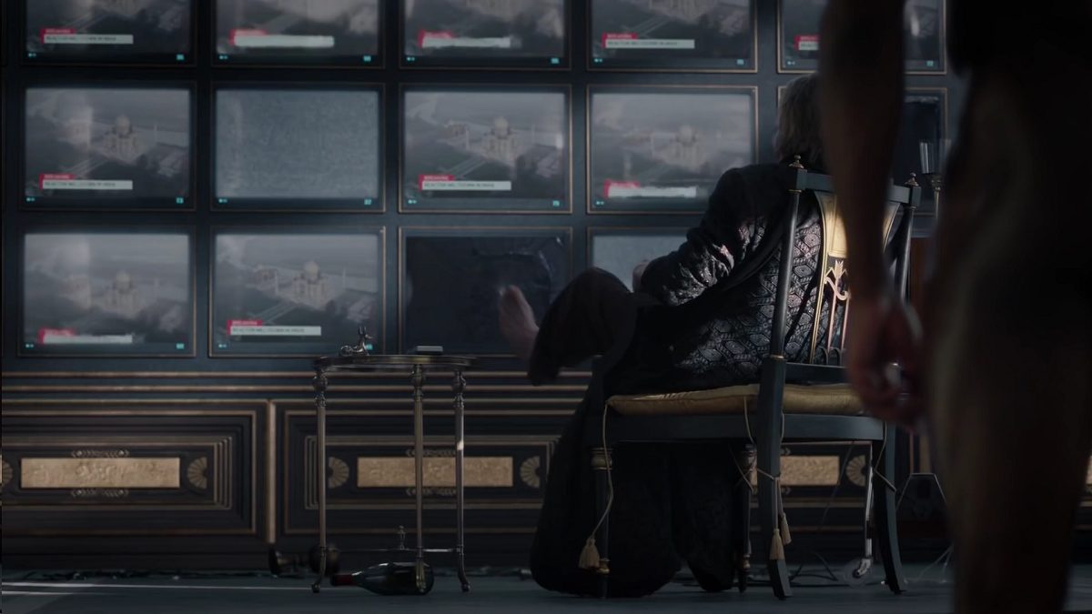 Watchmen - Ozymandias sits with his feet propped at in front of a bank of TV monitors, some of which are dead or broken