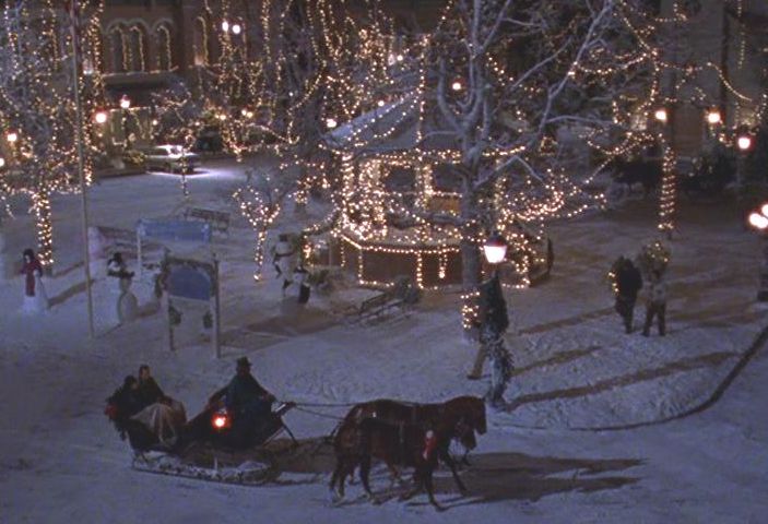 Stars Hollow covered in snow, the gazebo next to a snowman contest and a horse drawn carriage