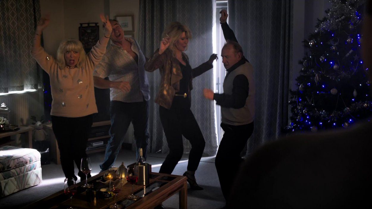 Pam, Mick, Dawn, and Pete dance around a dark living room as they get stoned