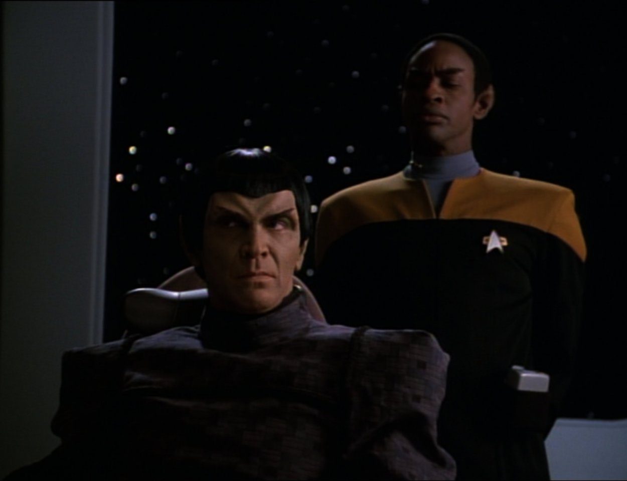 Tuvok stands behind a Romulan