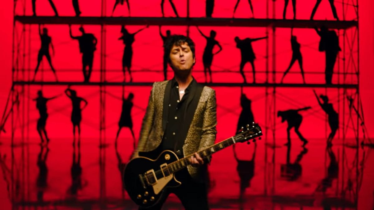 Billy Joe Armstrong and backing dancers in red squares in the video for Green Day's Father of All...