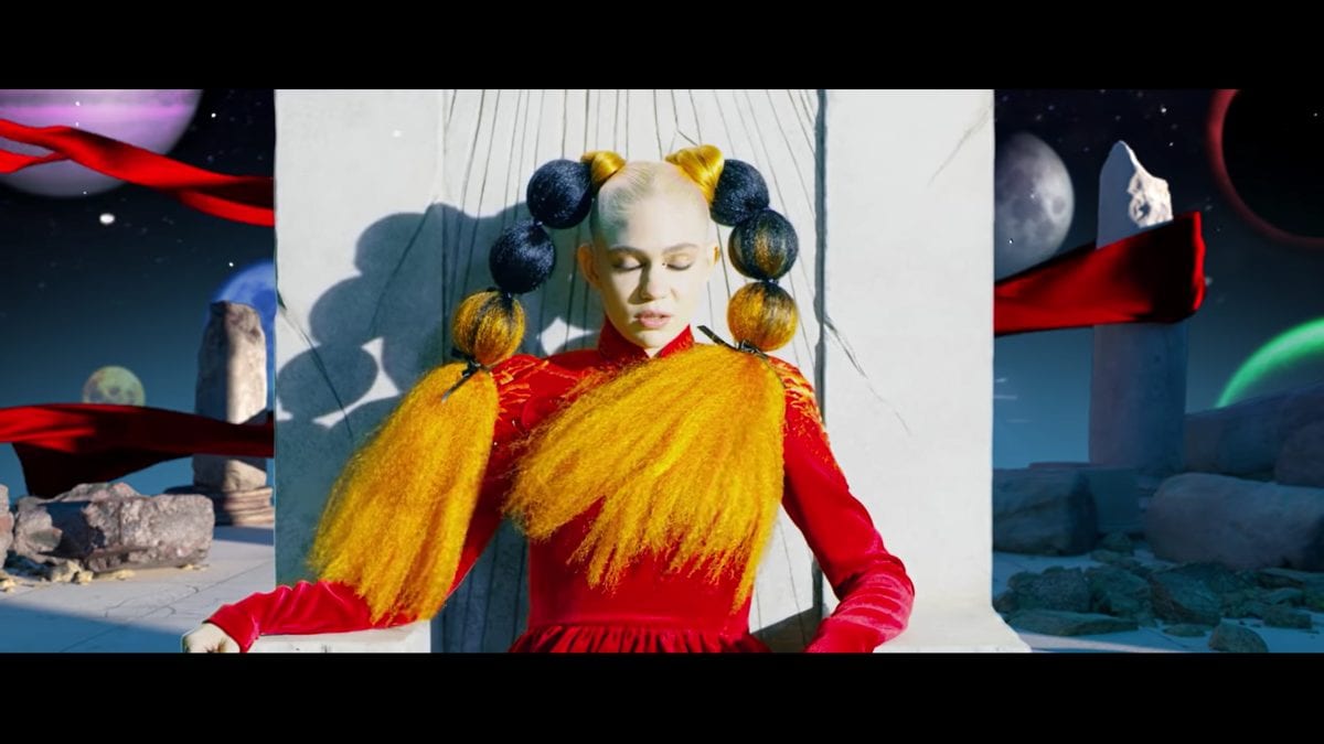 Grimes sits on a throne in a strange world in the video for Delete Forever