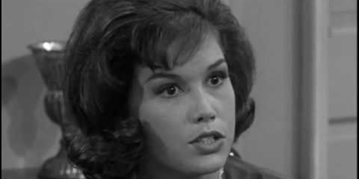Picture in black and white, Mary Tyler Moore looking straight ahead with intensity, but the camera angle is from the side, capturing Mary Tyler Moore at an angle