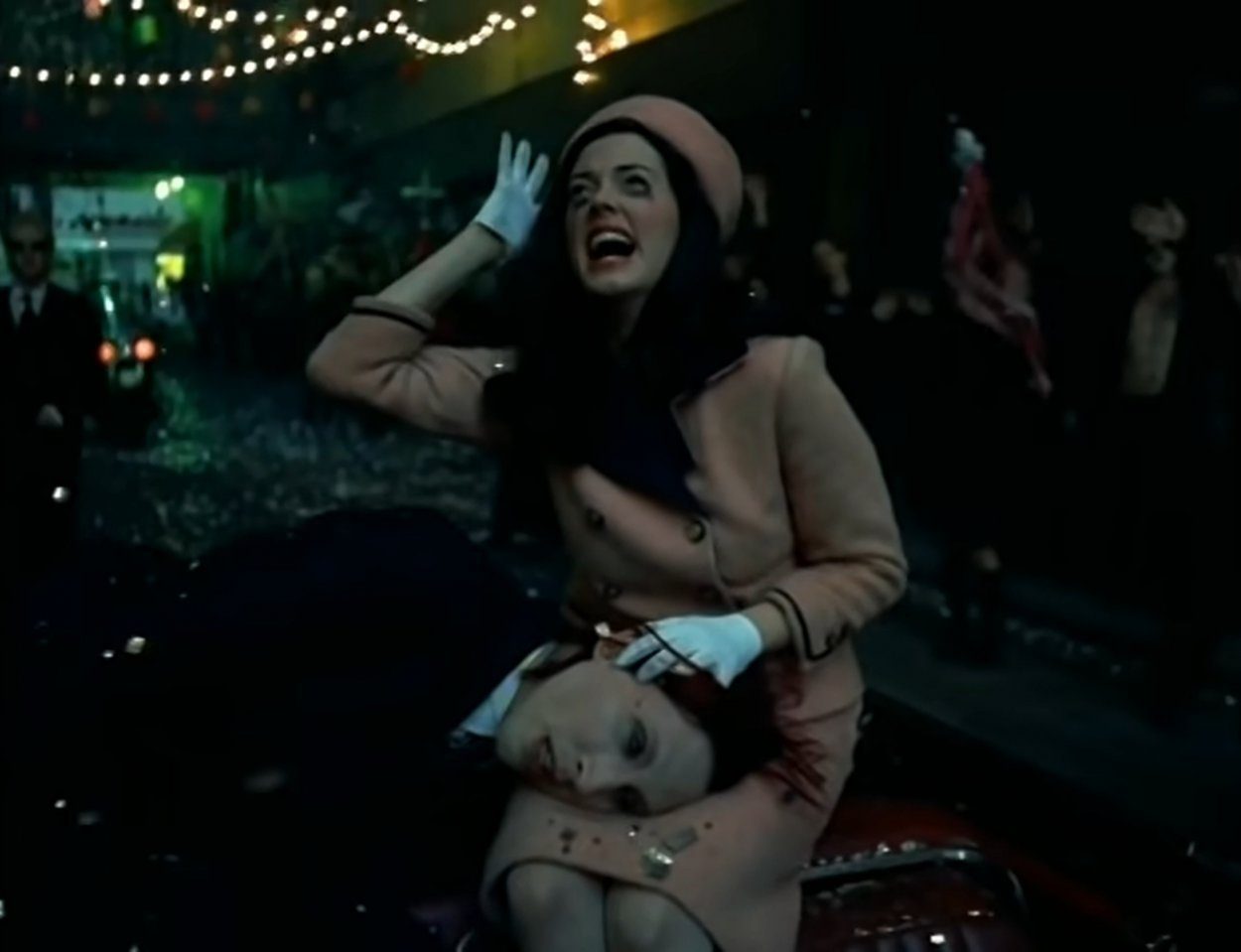 Marilyn Manson as JFK having just been shot, lying in the lap of Rose McGowan as a distraught Jacqueline Kennedy, in the "Coma White" music video