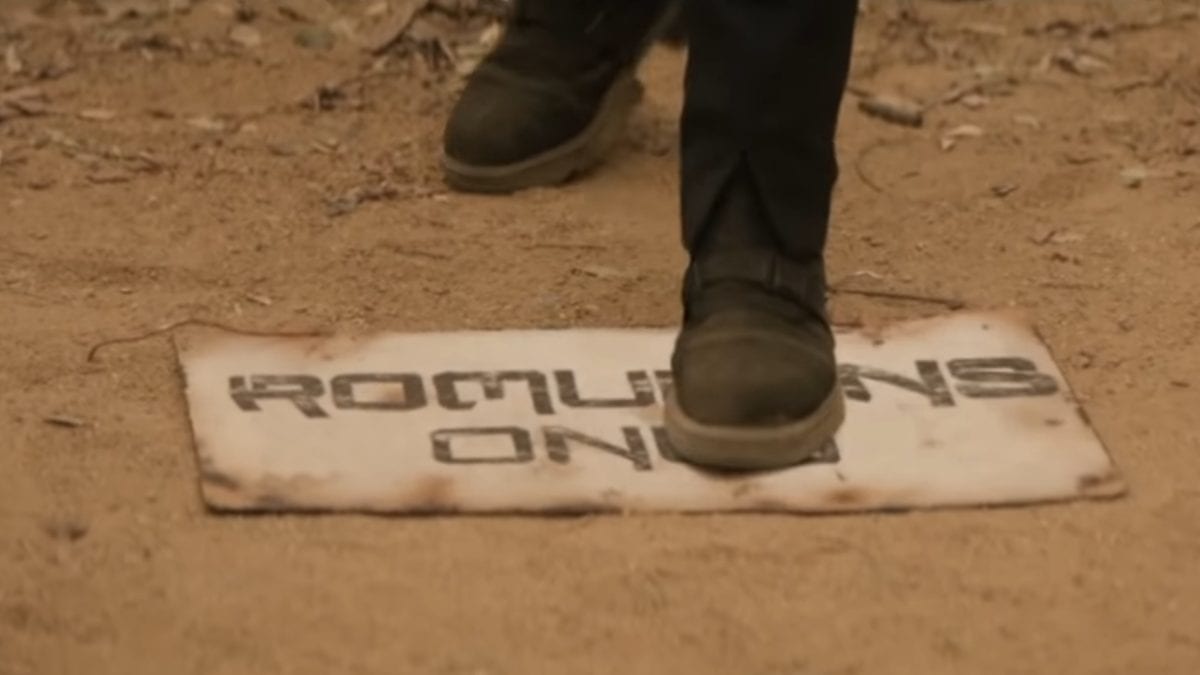 Picard S1E4 - A booted foot steps on a "Romulans Only" sign in the dirt