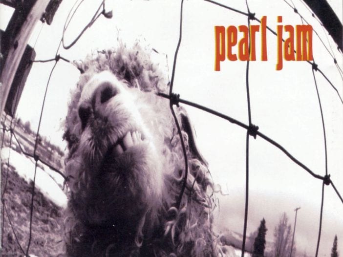 A black and white image of a sheep’s head behind a fence. “Pearl Jam” is in red.