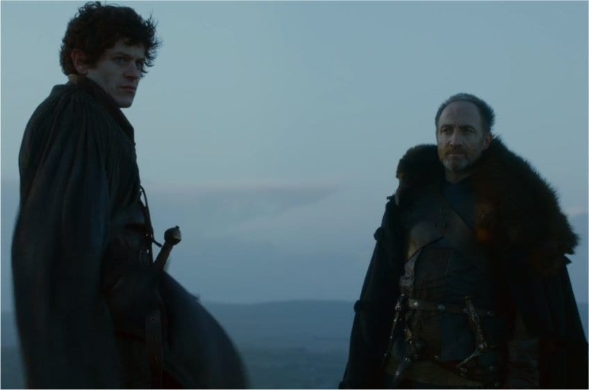 Ramsay and Roose Bolton stand across from each other on a the top of a mountain.