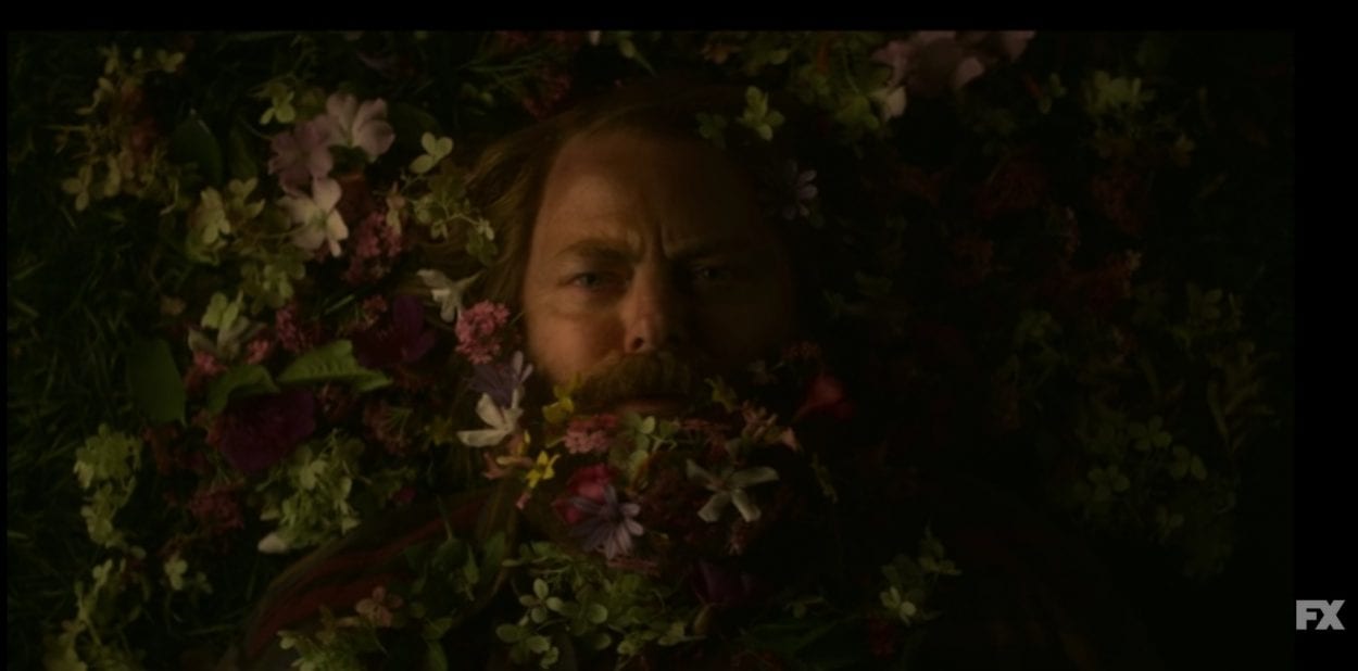 A sad-looking Forest surrounded by flowers in Devs S1E6