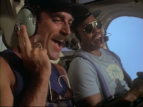 Magnum and TC are riding in TC's helicopter and laughing