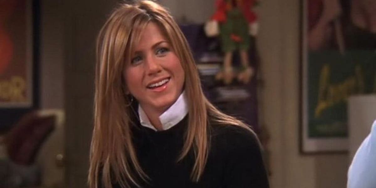 Rachel smiling and looking to her left on Friends