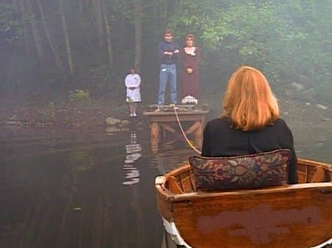 Mulder—arms crossed, and Melissa Wait on the dock in the distance, while we see the back of Scully in the back of a tiny lifeboat tethered to the dock.