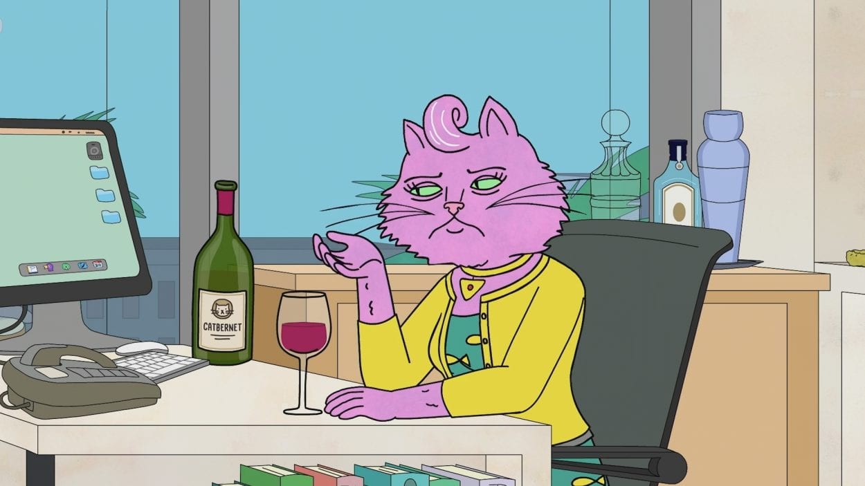 Princess Carolyn sits at her desk with a glass of wine