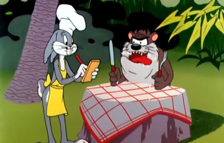 Bugs Bunny, dressed as a chef, takes the order of the impatient Tasmanian Devil, who waits with panting tongue, and fork and knife in hands.