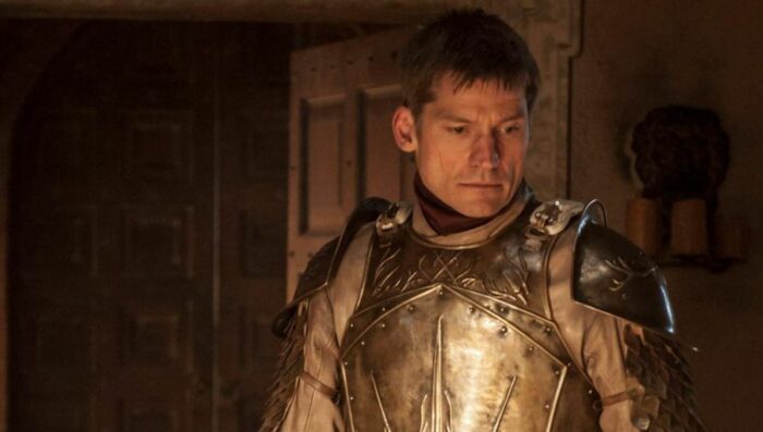 Jamie Lannister looks down wearing his armor but no helmet
