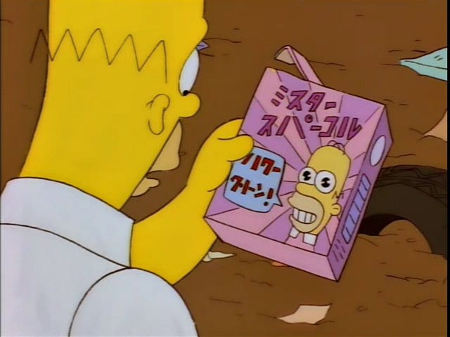 Homer looks at the "Mr. Sparkle" box with his face on it