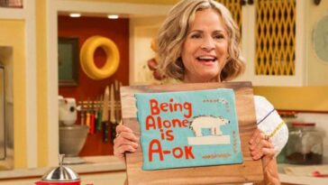 Amy Sedaris holds a sign that says "Being Alone is A-OK" in At Home with Amy Sedaris