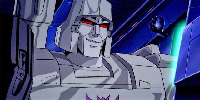 The Decepticon Megatron sneers while watching a computer screen.