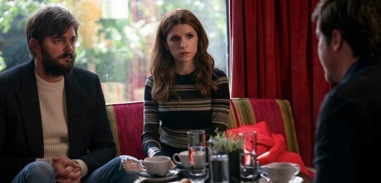 Magnus and Darby (Nick Thune and Anna Kendrick) sit across the table from a man whose back is facing us.