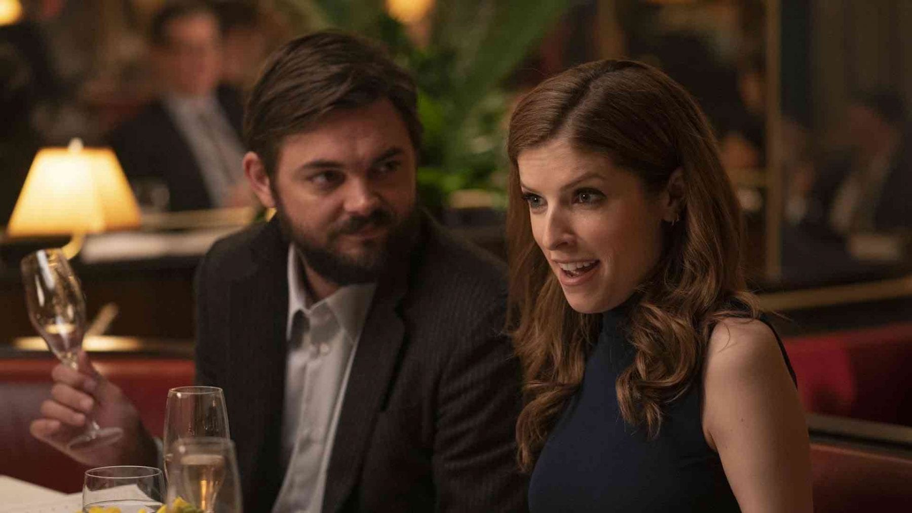 Magnus and Darby (Nick Thune and Anna Kendrick) sit in a restaurant together. Magnus looks at Darby, and Darby looks in bewilderment at an unseen dinner guest.