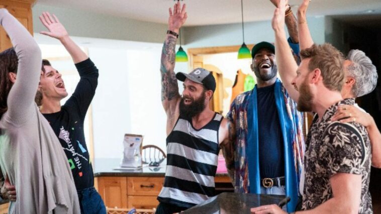 The Queer Eye crew raises hands in the air
