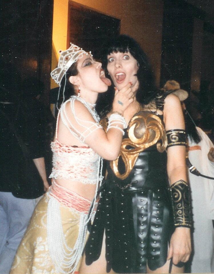 Cosplayers reenact a scene in which a demon-possessed Gabrielle licks Xena up the side of her face