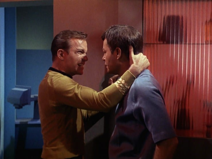 Kirk forcefully grabs McCoy's neck in sickbay