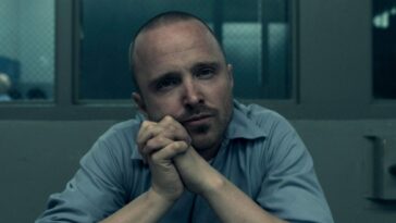 Warren (Aaron Paul) leans with his head towards his hands in Truth Be Told