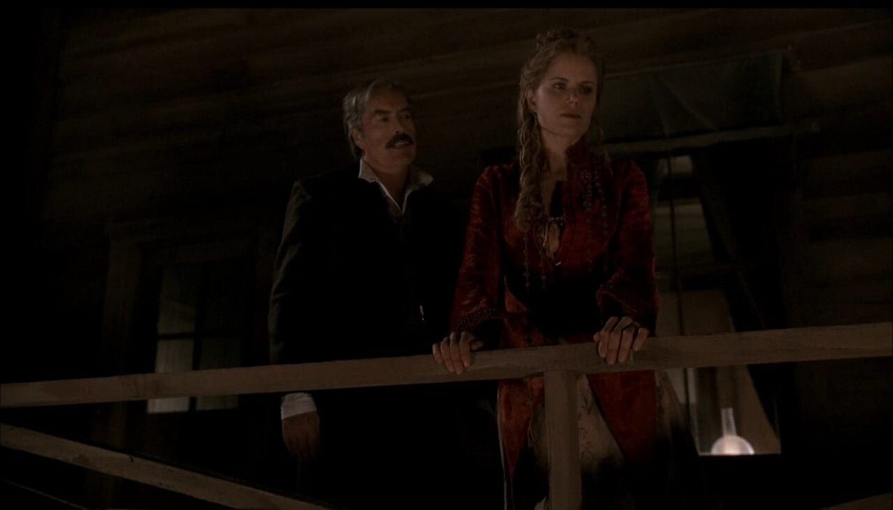 Cy (Powers Boothe) checks in on Joanie (Kim Dickens) in a scene from Deadwood.