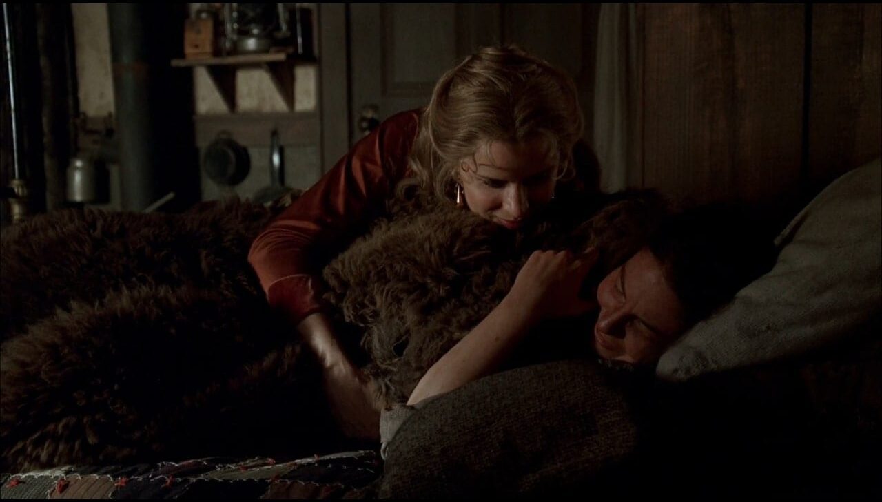 Joanie (Kim Dickens) snuggles with Jane (Robin Weigert).