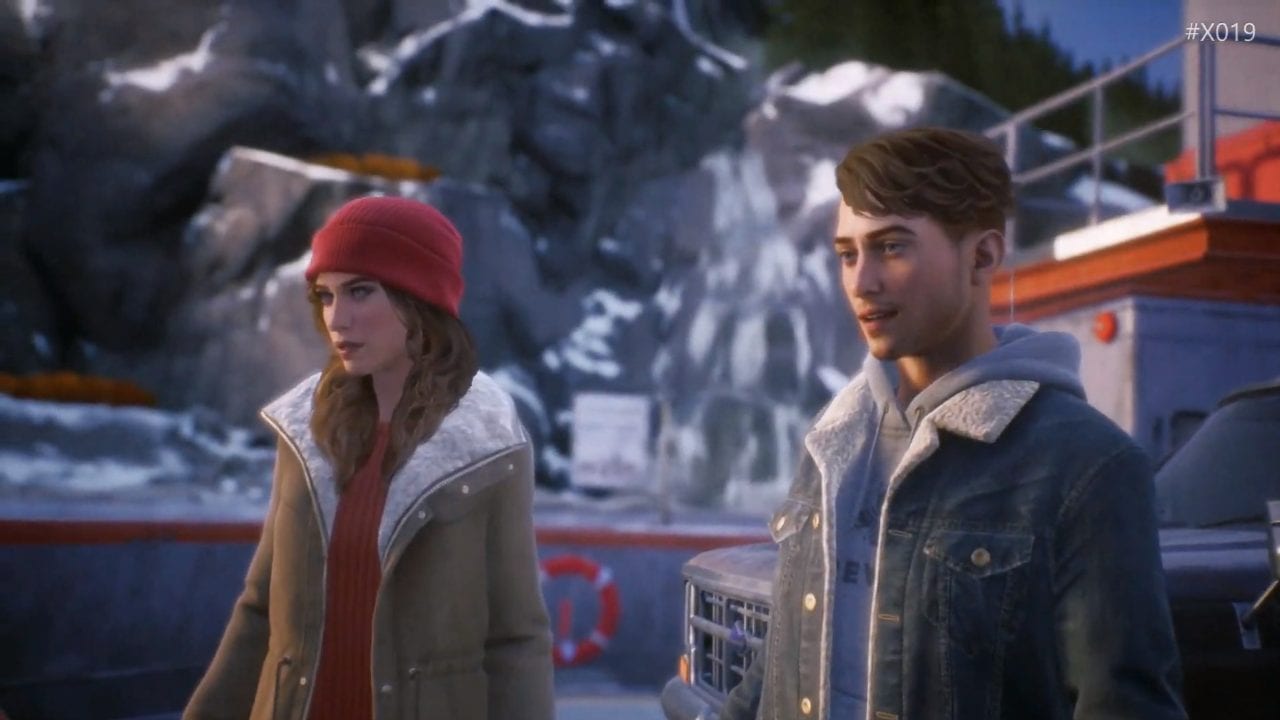 tyler and alyson stand in front of a snowy mountain