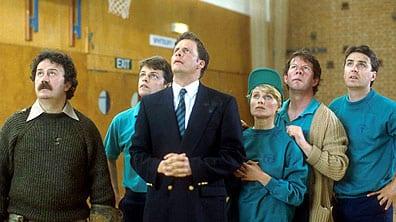 Mr Brittas and his staff stare upwards and look confused