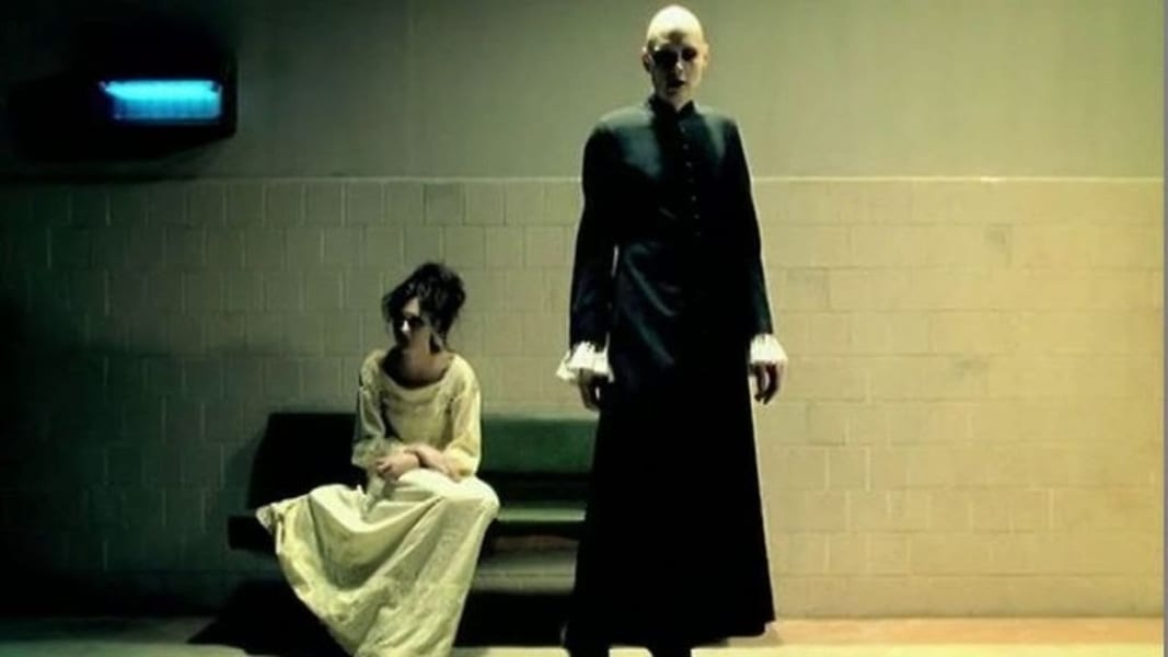 Billy Corgan standing by a seated woman