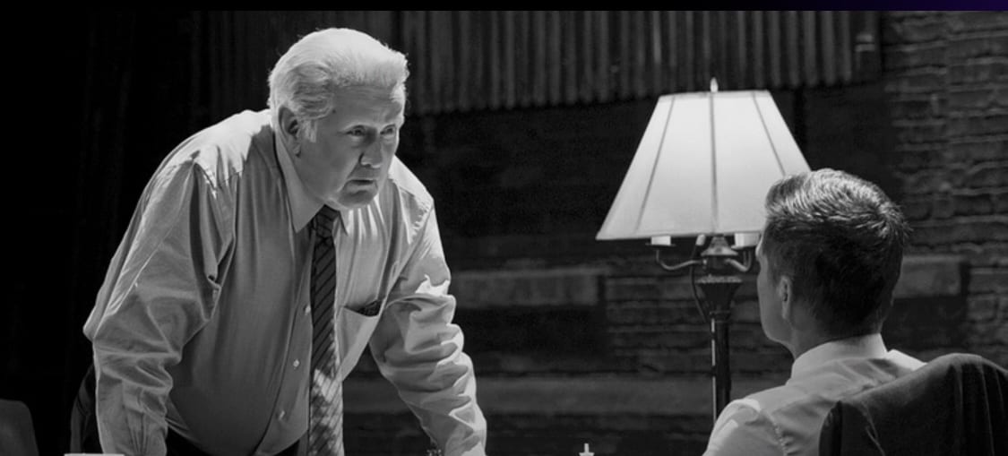 black and white shot of President Bartlet talking to Sam Seaborn over a chessboard