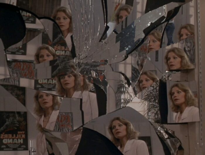 Karen looks into a shattered mirror that shows her face in every shard