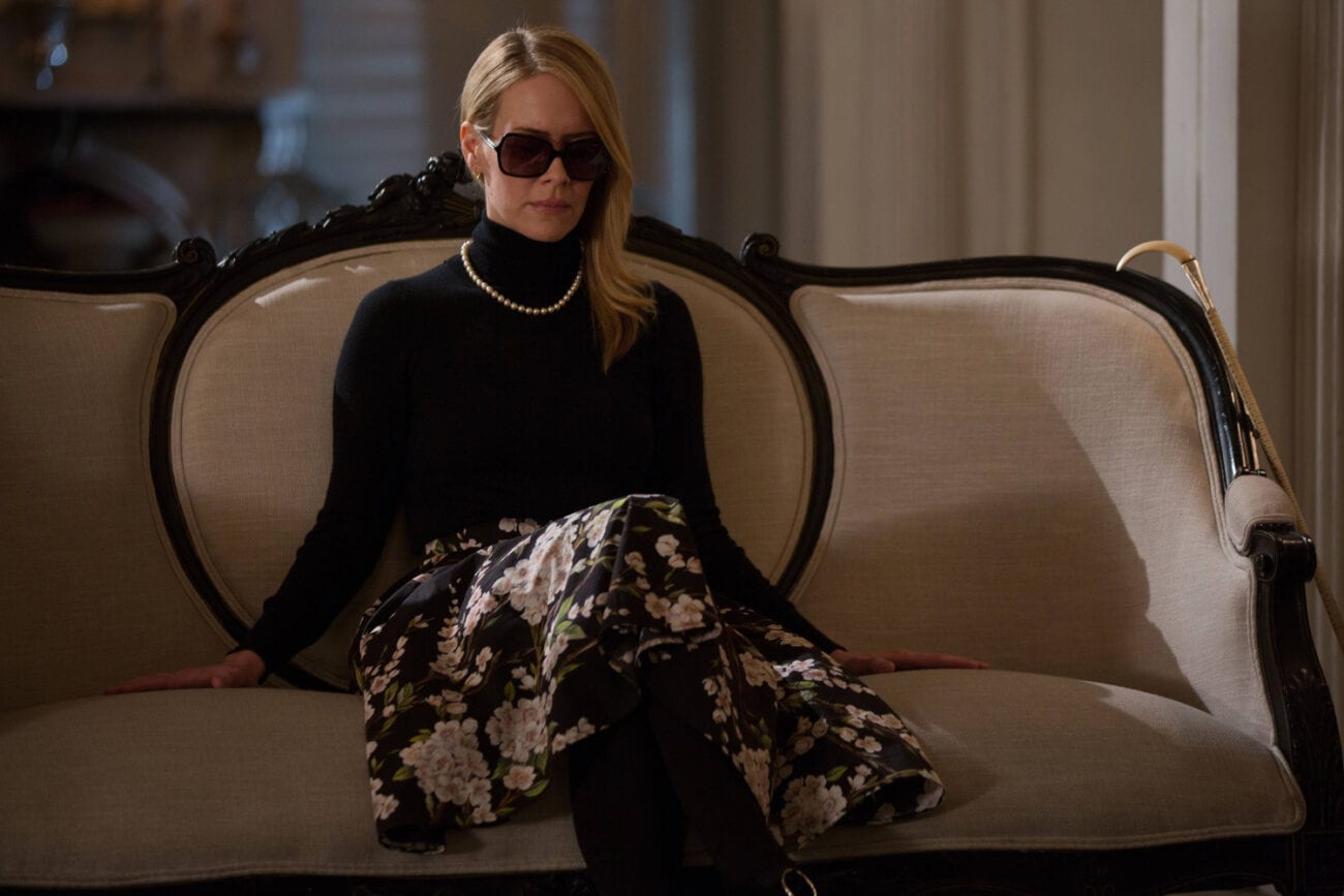 A blind Cordelia wearing sunglasses on the couch