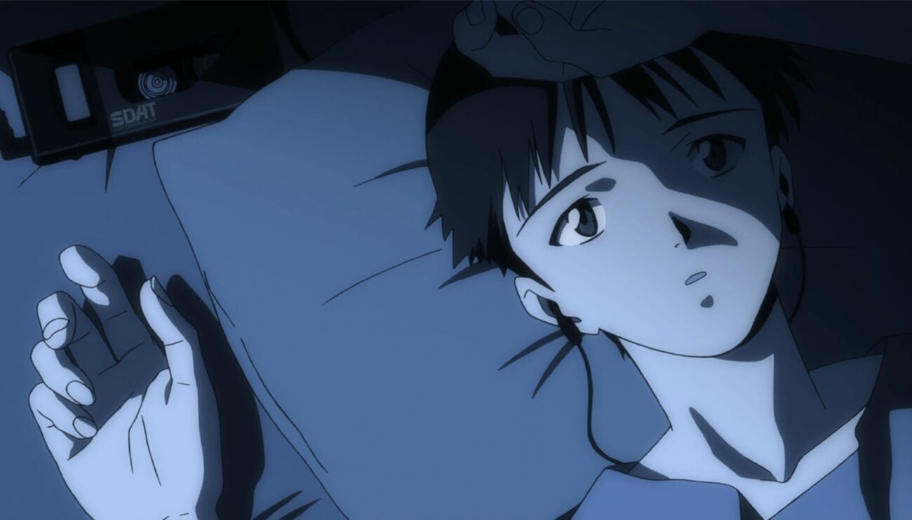 Shinji lying on his bed at night with earbuds in