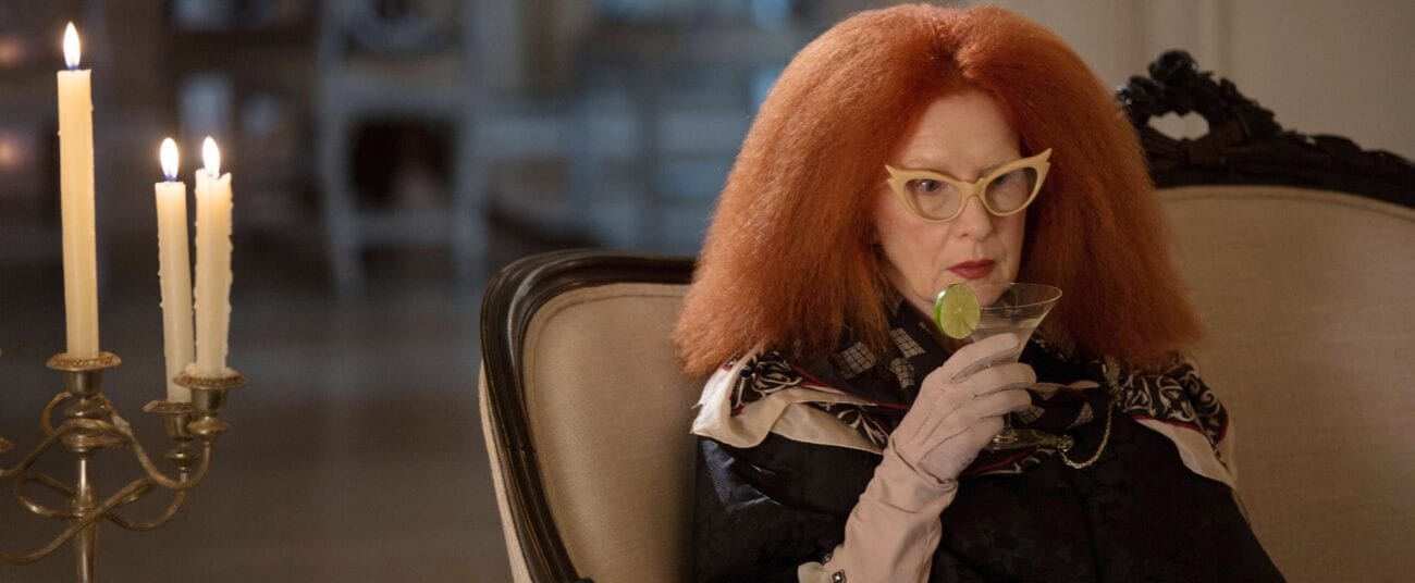 Myrtle Snow drinks a cocktail