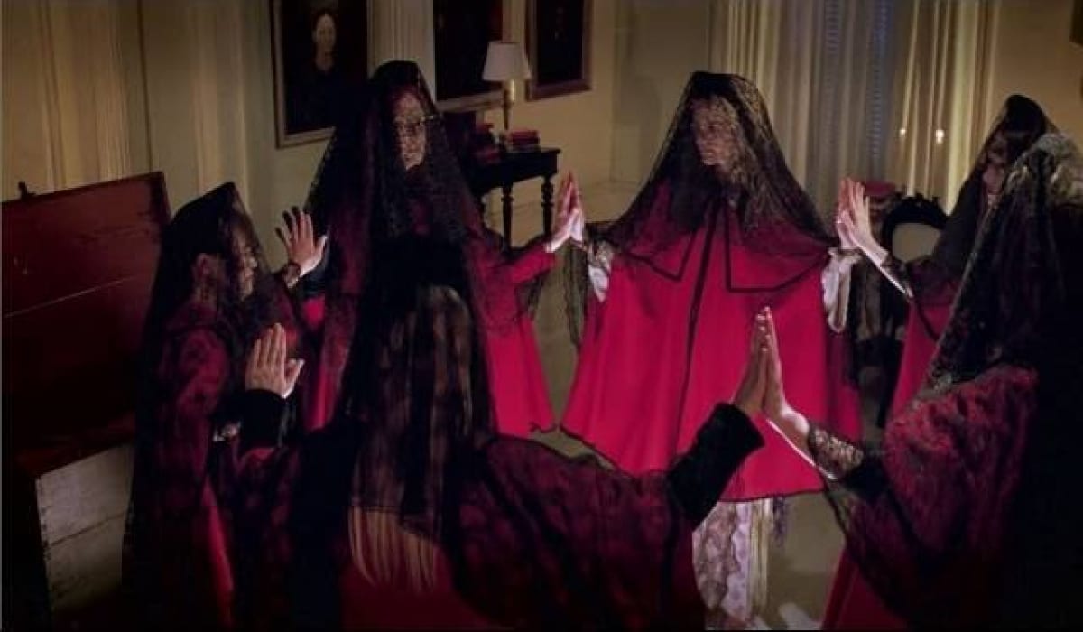 The coven of witches gather in a circle