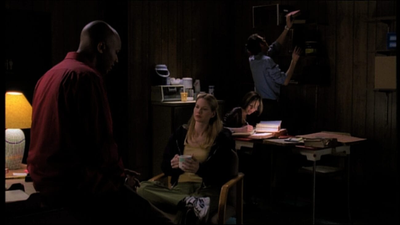 In Angel Investigations' new office, Anne sits in a chair with a mug of something and Gunn leans on a desk opposite her, while in the background Cordelia works at a desk and Wesley grabs a book from a shelf