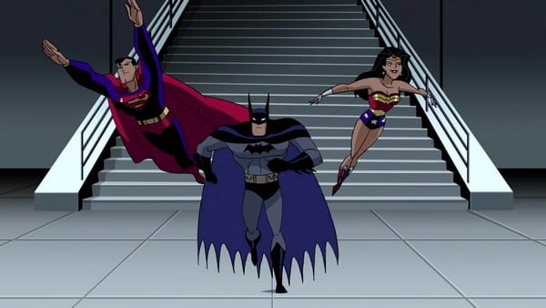 Superman, Batman, and Wonder Woman approach the camera in the final shot of the series. Superman and Wonder Woman are flying, Batman running.