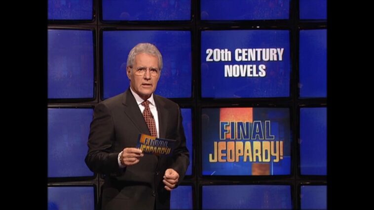 Ale Trebek stands in front of a Final Jeopardy! board with a category that reads 20th Century Novels