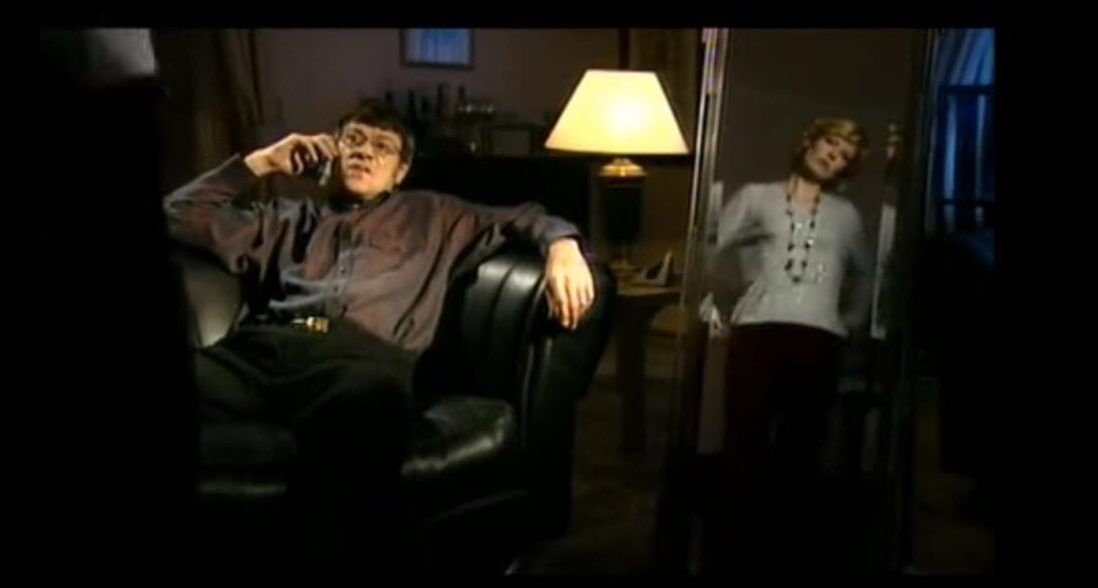David Cann and Julia Davis lazily discovering their son is dead via a phone call in episode 5