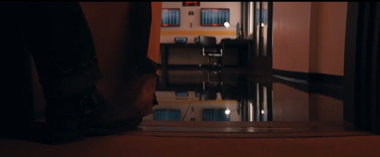 The Stand S1E1 - A boot holds a sliding door open, some sort of control center in the room beyond it