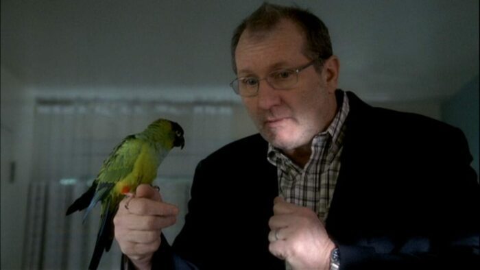 Bill holds his bird Zippy on his finger 