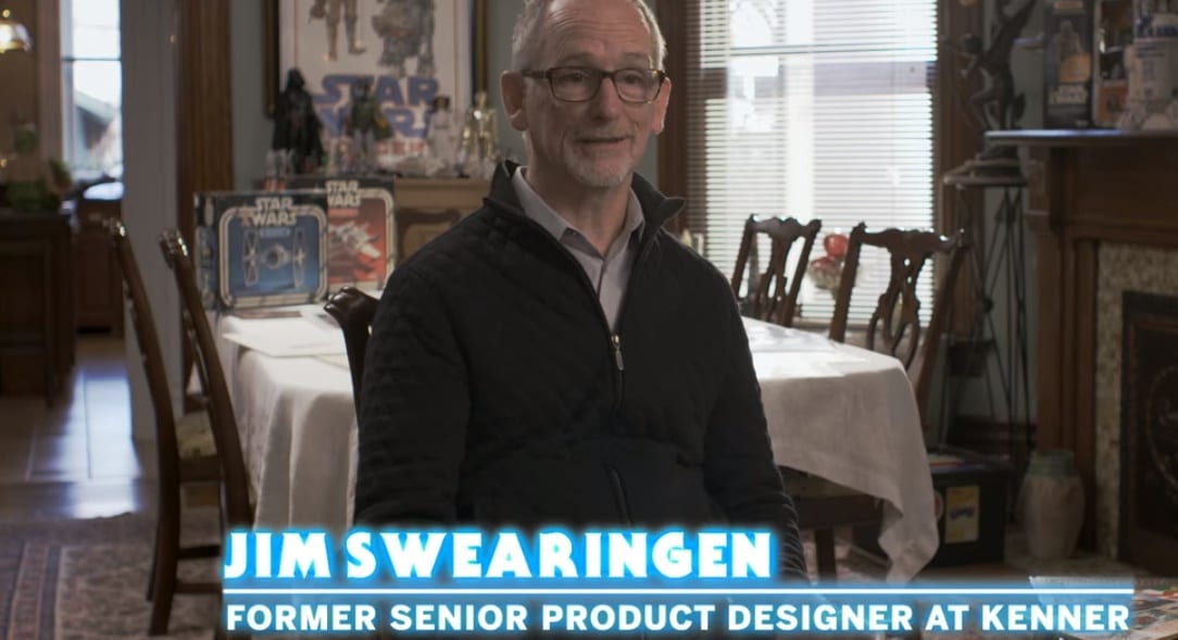 Talking head shot of Jim Swearingen (chyron reads Former Senior Product Designer at Kenner) sitting in his dinig room