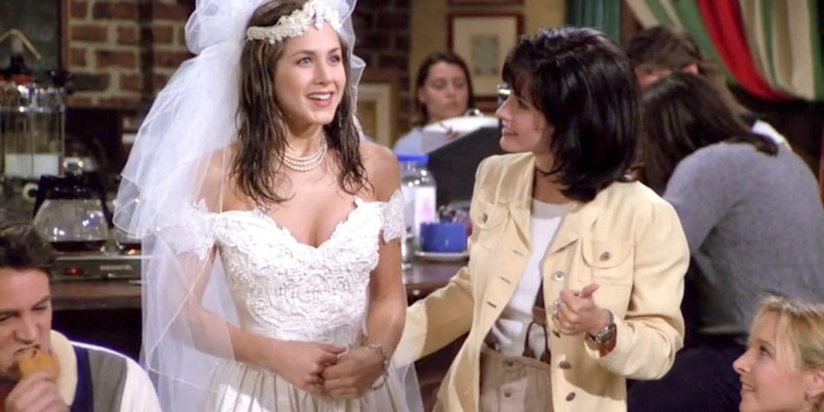Rachel in a wedding dress beside Monica, with Chandler on lower left and Phoebe on lower right in the Friends pilot episode