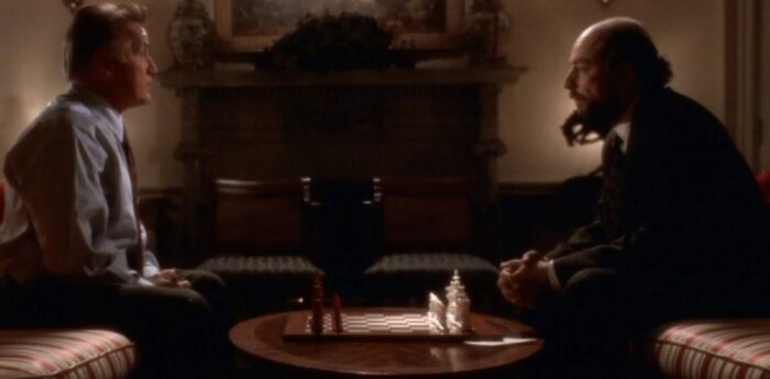 President Bartlet (Martin Sheen) and Toby (Richard Schiff) sitting in the Oval Office on couches with a chess set between them