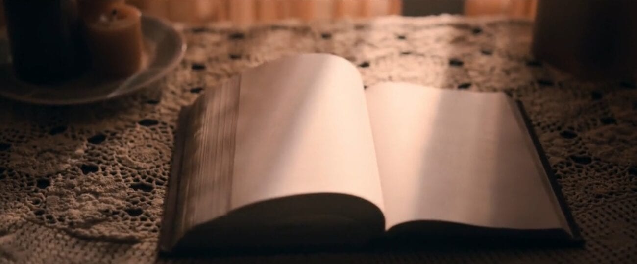 The Stand S1E3 - A book of blank pages is opened up on a nice table in front of a curtained window