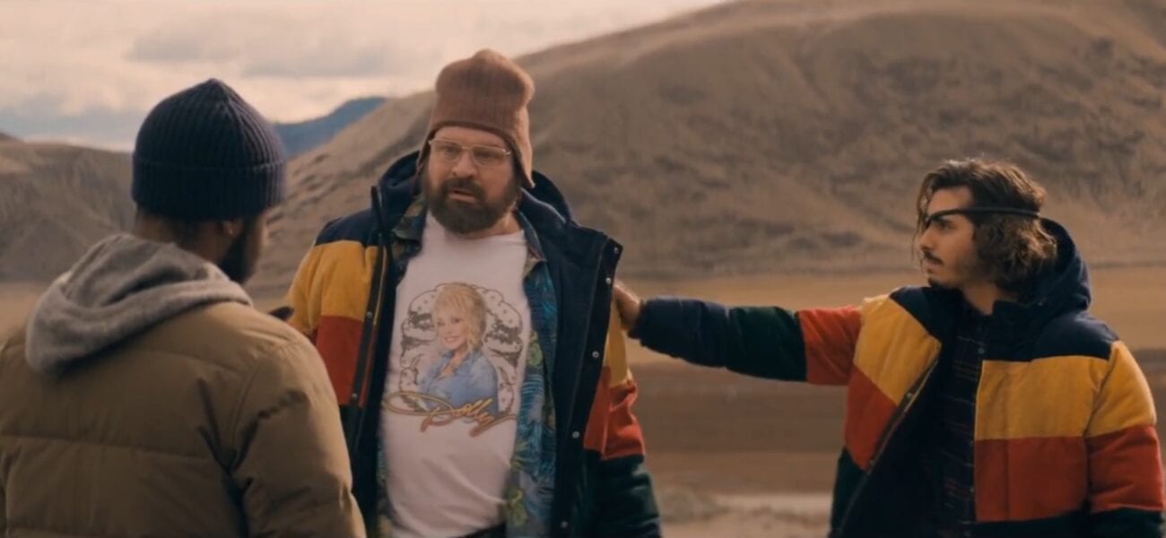 Larry faces Tom and Nick, wearing matching jackets, standing outside in the mountains in The Stand Episode 4
